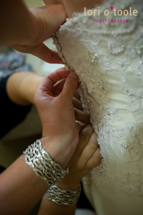 buttoning the wedding dress
